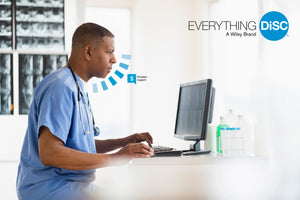 Doctor in Blue Scrubs with stethoscope around neck sat at computer screen..  Everything DiSC logo in top right of screen