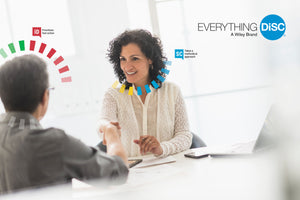 Woman shaking Man's hand in business meeting.  Everything DiSC logo in top right of screen